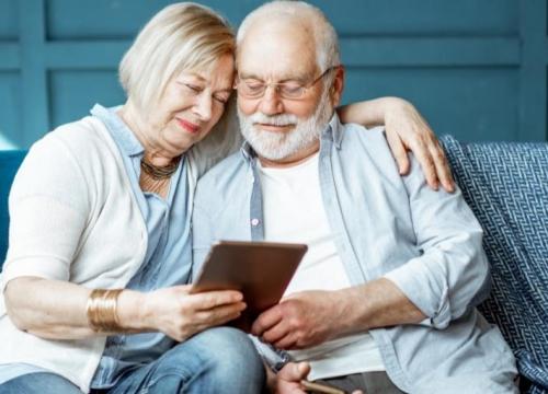 Couple sitting on the couch on a tablet