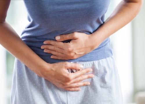 Lady holding her stomach in pain
