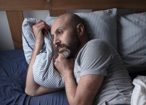 Man struggling to sleep