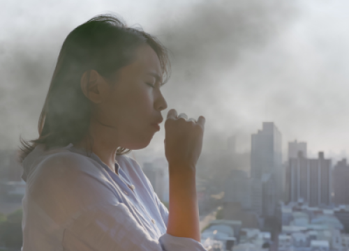 woman coughing from air pollution