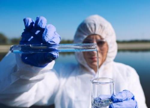Researcher studying a sample of water