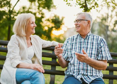 couple talking on a bench