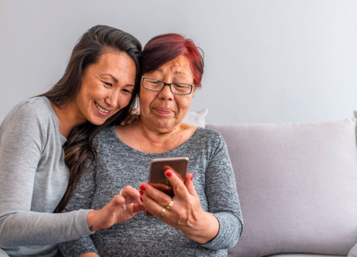 Older and younger women using a smart phone