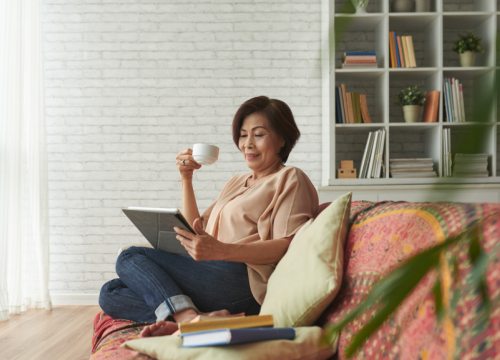 Woman relaxing on the couch drinking coffee