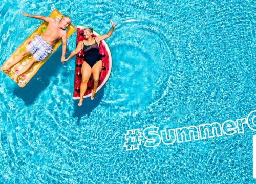 Older couple floating in a pool