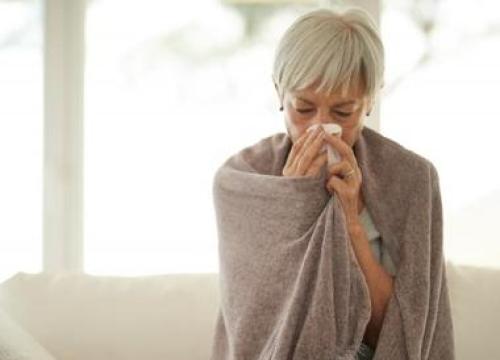 Woman blowing her nose
