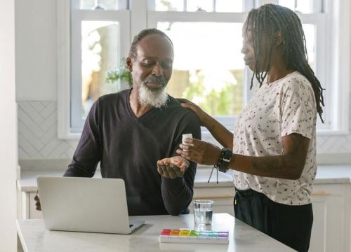 Woman giving man pill