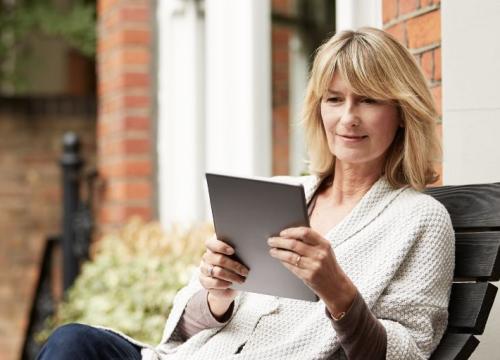 Woman using tablet outside