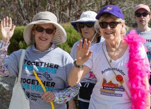 Women waving as they walk for Parkinson's Moving Day