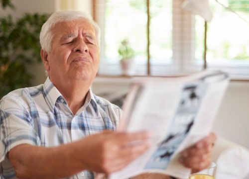 Man struggling to read