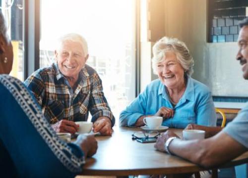 Senior friends talking over coffee