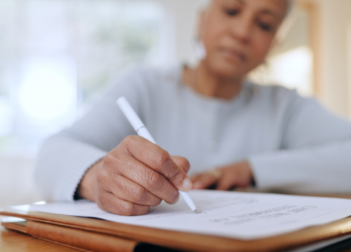 cropped image of an older lady filling out a survey