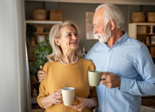 Elderly couple enjoying coffee together at home