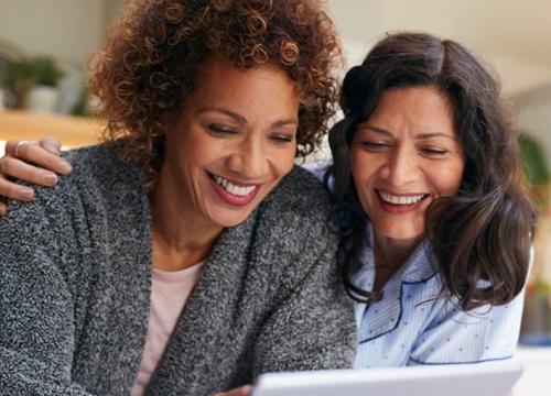 2 women looking at ipad