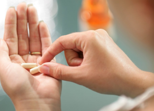 Woman holding a pill