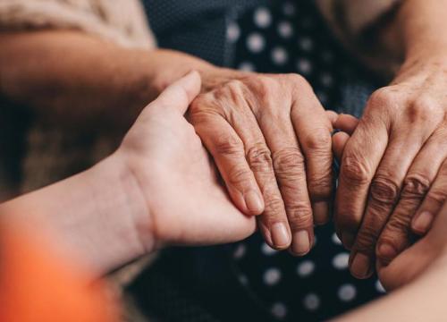 group of hands holding on to each other