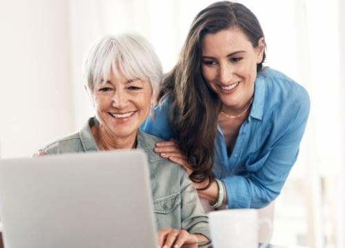 Mother and daughter looking at laptop together