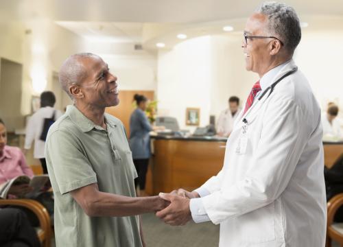 Doctor holding hands with patient