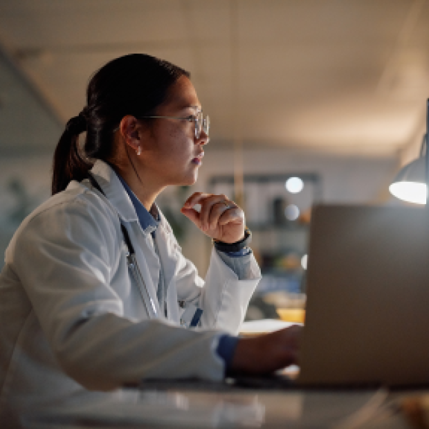 Woman sitting at desk working on computer