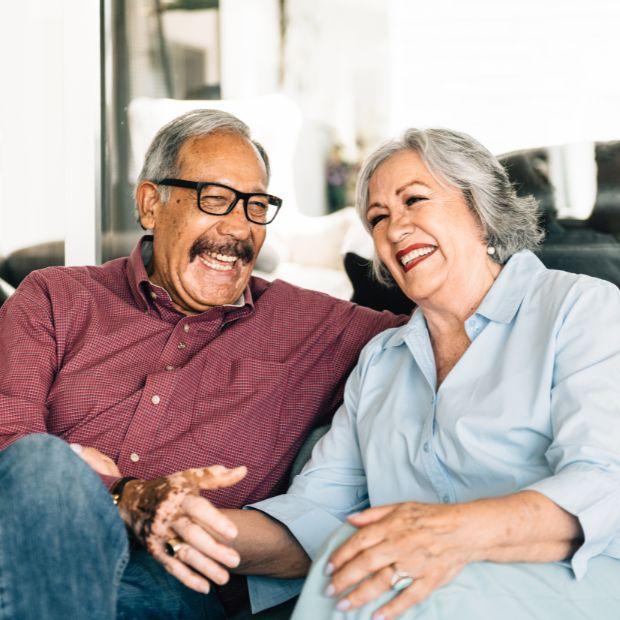Couple sitting on couch smiling