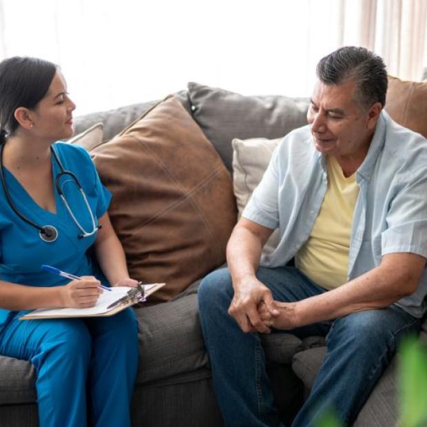 Nurse talking to a man during consultation