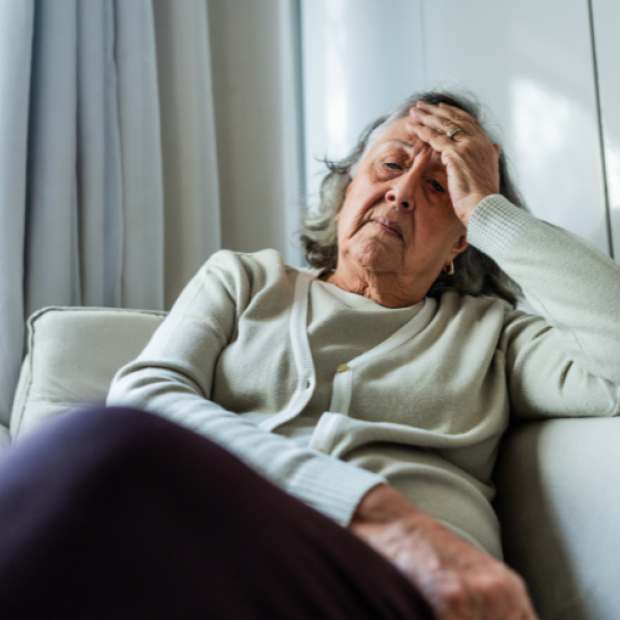 Women sitting on couch in pain