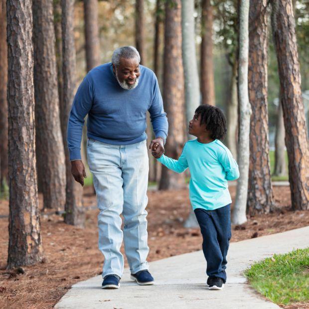 Grandpa and grandson walking in a park