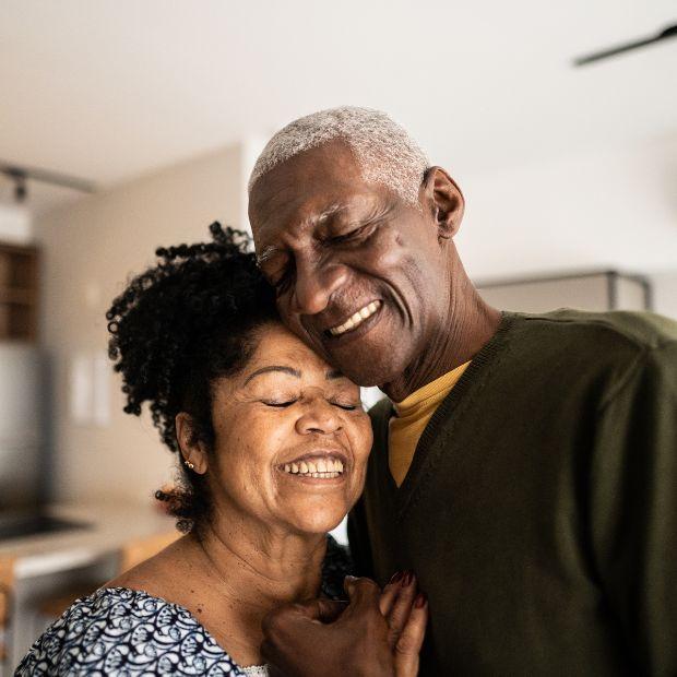 Couple hugging each other closely smiling