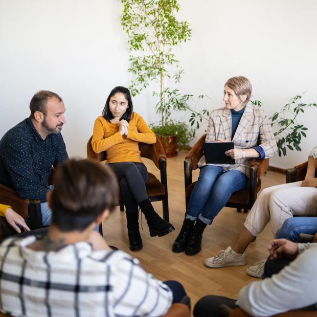 A group of people sitting in a circle at a support group