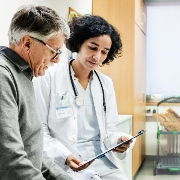Nurse sitting with patient going over paperwork