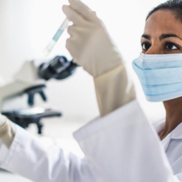 Researcher testing a vial in lab
