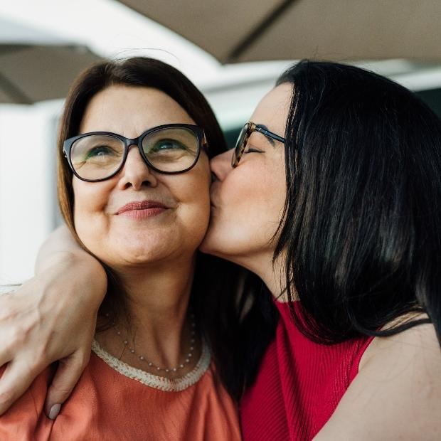 Daughter kissing mother on the cheek