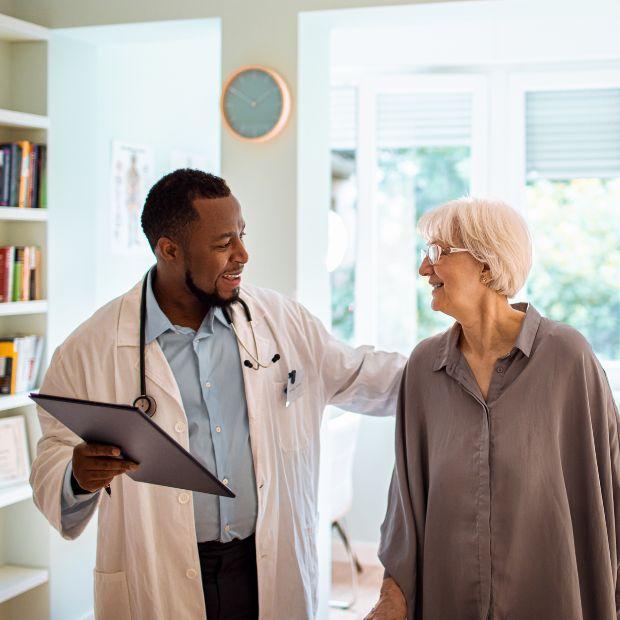Male doctor with female patient, patting her back