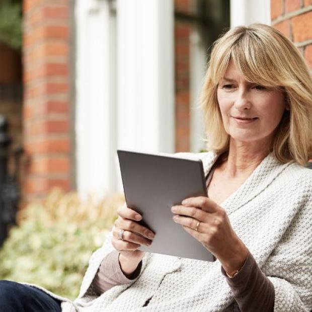Woman using tablet outside