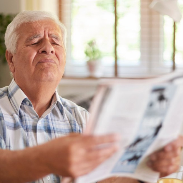 Man struggling to read
