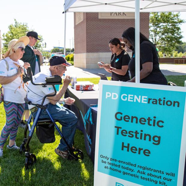 People visiting a booth for PD GENEration testing in Omaha