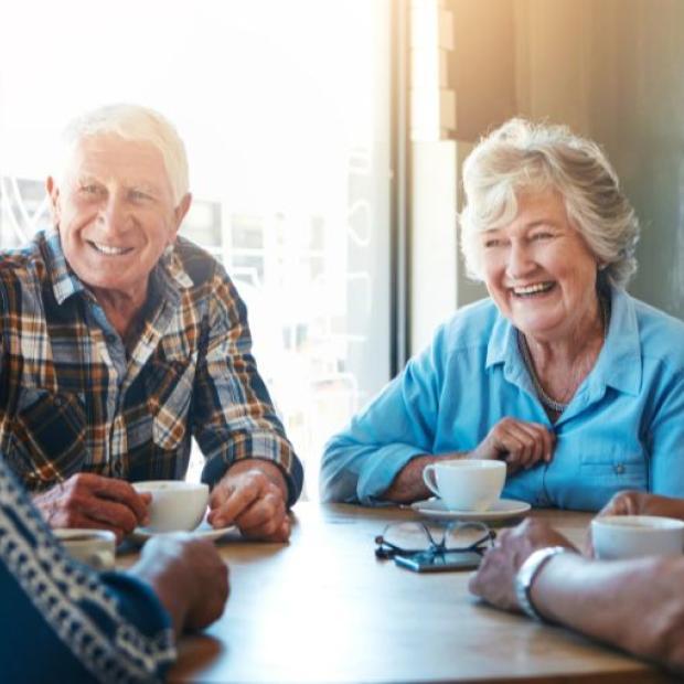 Senior friends talking over coffee
