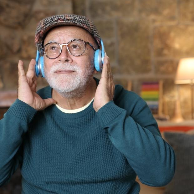 Man with headphones on listening to podcast