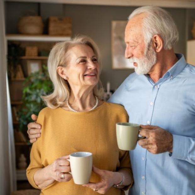 Elderly couple enjoying coffee together at home