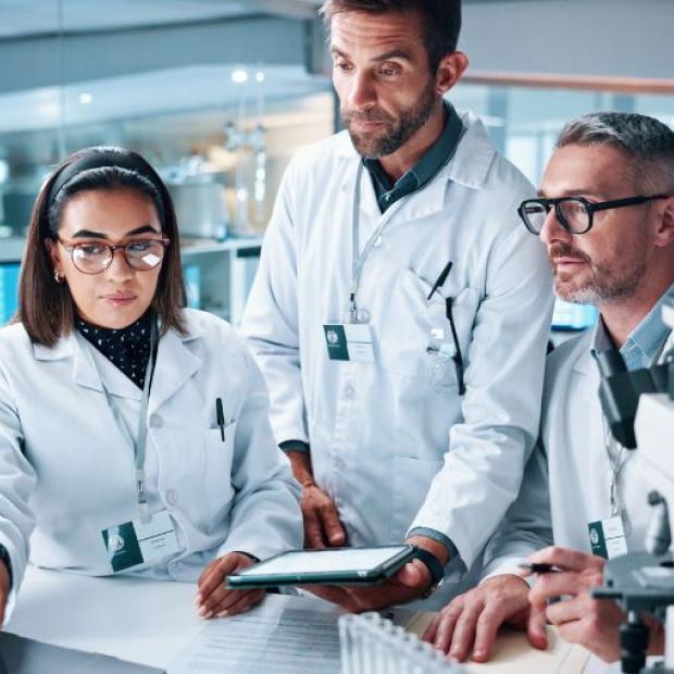 Researchers in a lab looking at a computer
