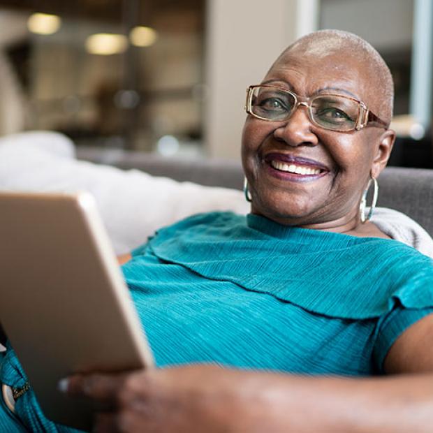 Wellness Wednesday banner - woman with tablet smiles at camera