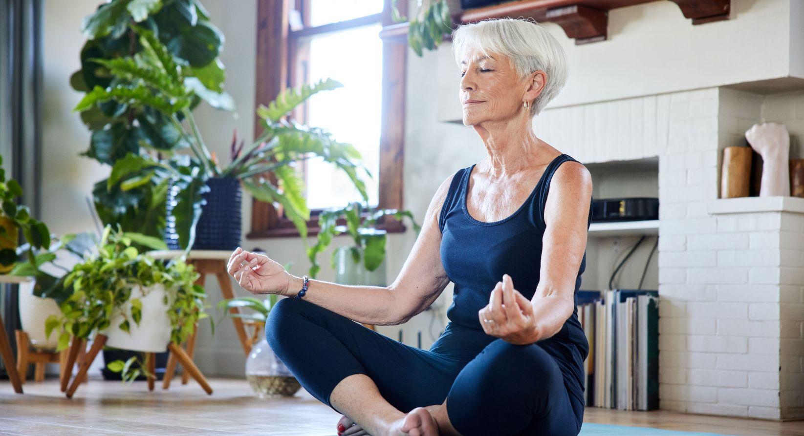 Woman meditating in her livingroom