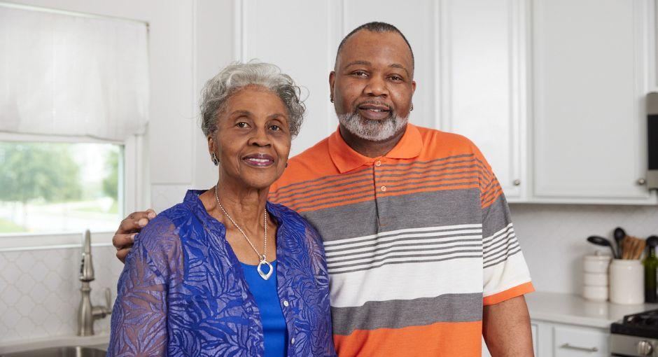 Black son with his arm wrapped around his mother