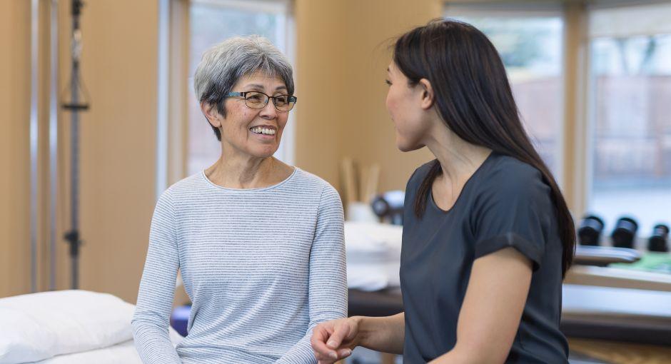 Physical therapist talking with her patient