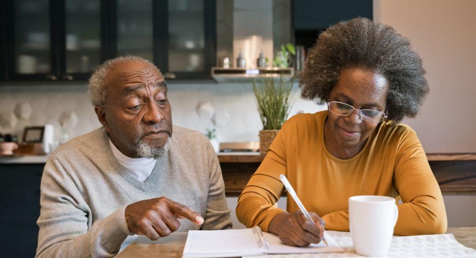 Wife taking notes while husband assists