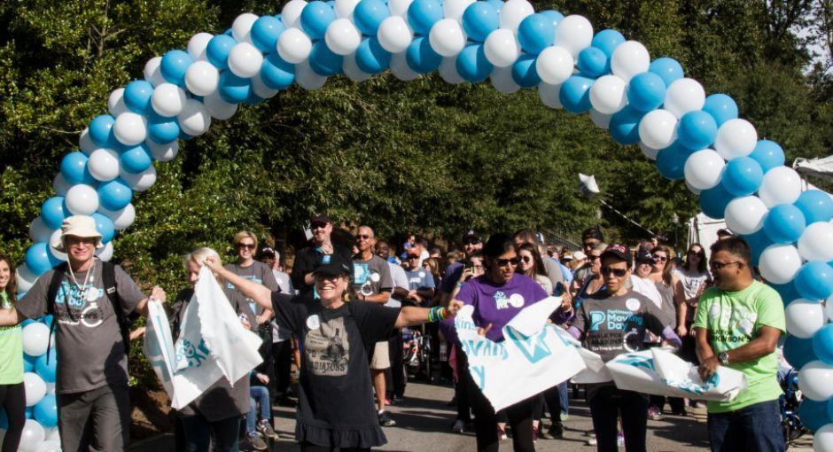 Group of people going through the finish line at a Moving Day Walk