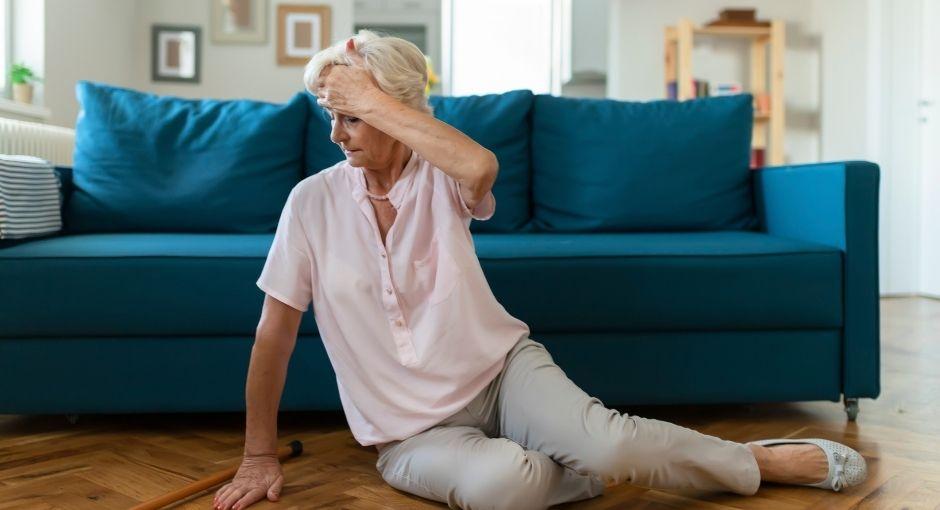 Lady got dizzy and fell on her living room floor and holding her forehead