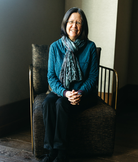 Kathy Blake sitting on a chair posing for a picture