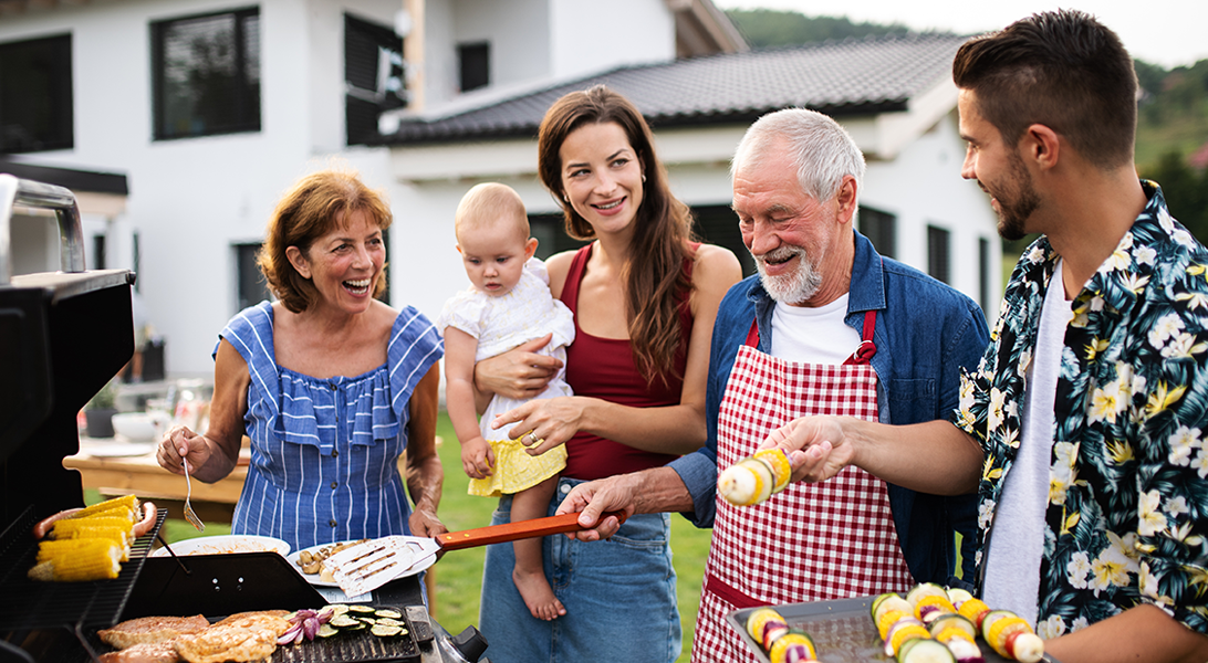 Three generations of a family having fun while barbequeing