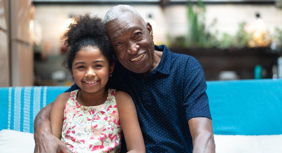 African American grandpa hugging his granddaughter